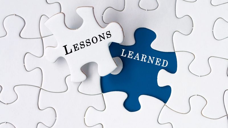 Lessons,Learned,Text,On,Jigsaw,Puzzle,Over,Dark,Blue,Background.